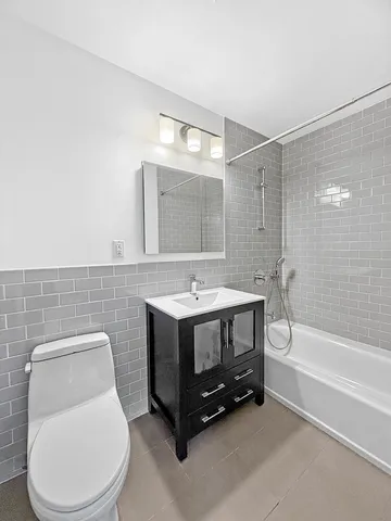 a bathroom with a toilet a sink and bathtub