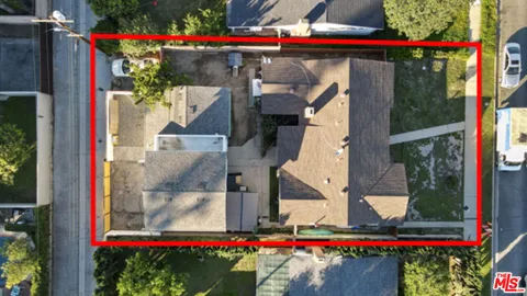 a small white building with a white and red umbrella