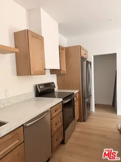 a kitchen with stainless steel appliances granite countertop a refrigerator and a sink