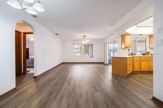 a view of a kitchen with wooden floor and a kitchen