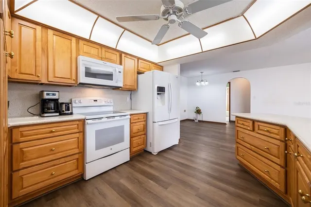 a kitchen with stainless steel appliances granite countertop a sink and cabinets