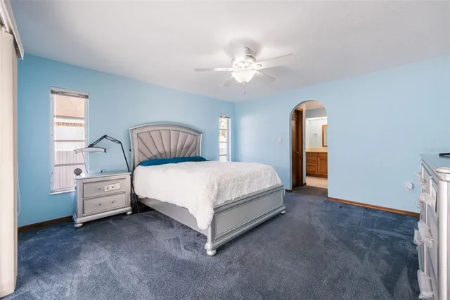 a bed room with a bed and a chandelier