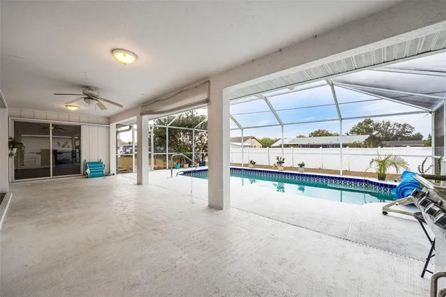 a view of a backyard with a wooden deck and dining table