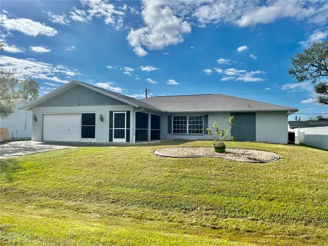 a view of a house with swimming pool and a yard