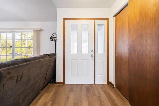 a view of a bedroom with wooden floor and windows