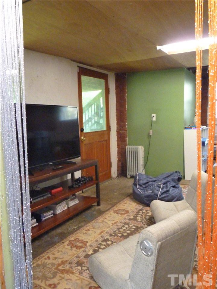 807 West South Street Raleigh, NC 27603 - Photo 24 of 30 Walk out into the backyard from the rec room. You can also access a huge walk-in crawl space from here if you need more storage!