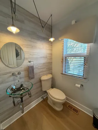 a bathroom with a toilet a sink and mirror