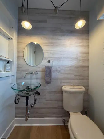 a bathroom with a toilet a sink and mirror