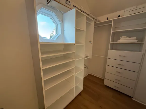 a view of walk in closet with empty racks