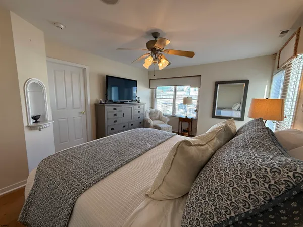 a bedroom with a bed and a flat screen tv