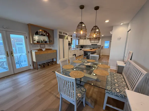 a view of a dining room with furniture wooden floor and a chandelier
