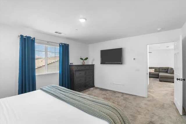 a backyard of a house with table and chairs with wooden floor