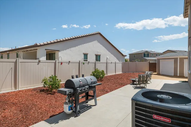 an aerial view of a city with lots of residential buildings and mountain view in back