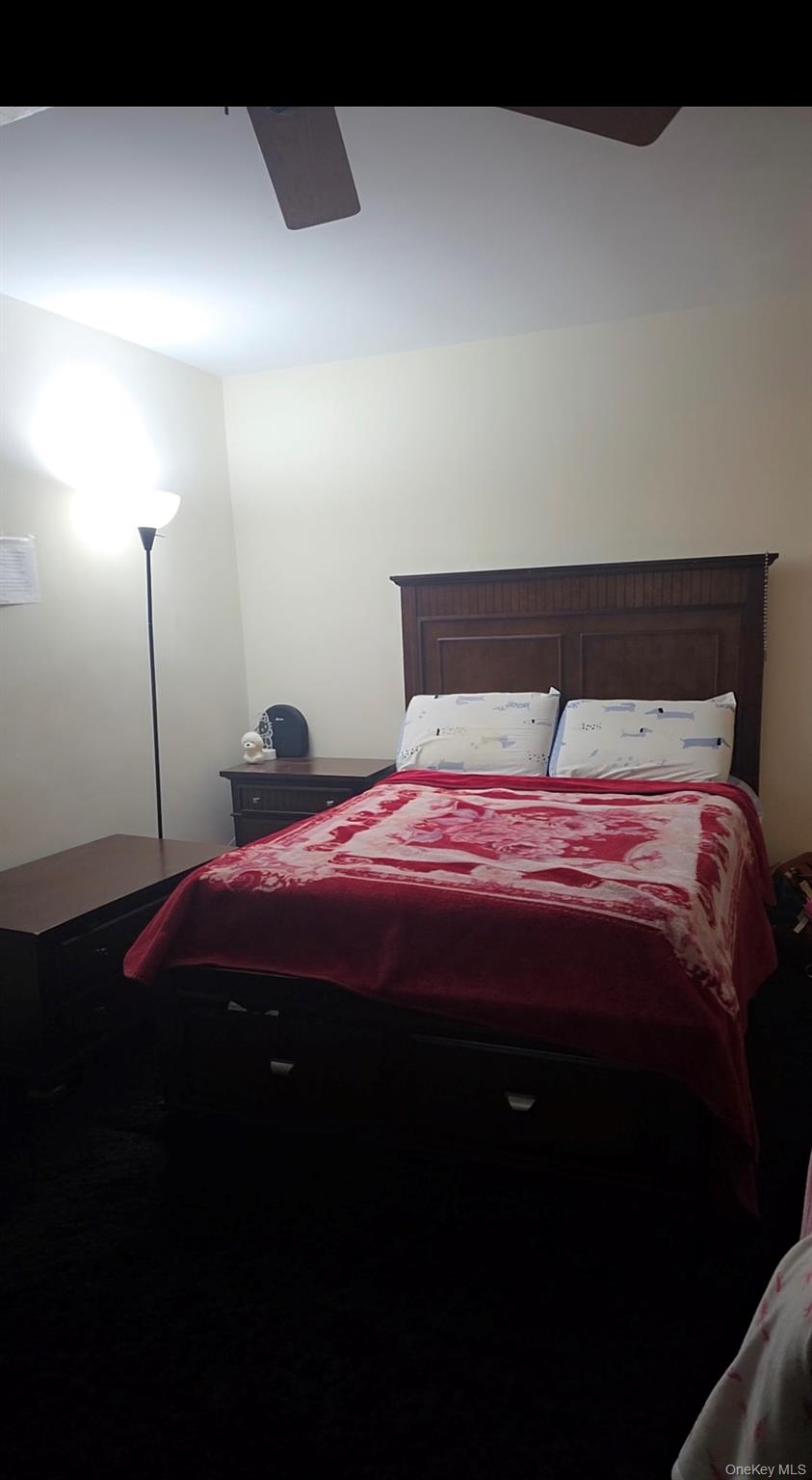 151-15 84th Street, Unit 6D Queens, NY 11414 - Photo 3 of 4 a bedroom with a bed and a night stand