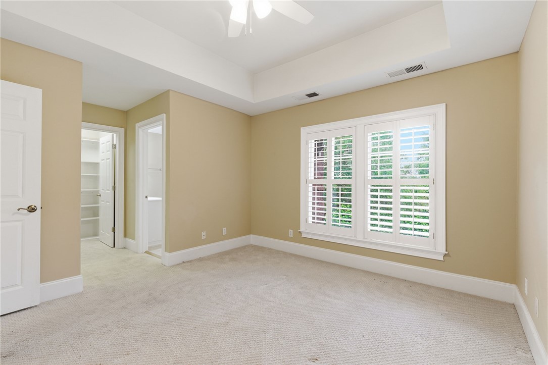 204 Butler Avenue Greenville, SC 29601 - Photo 22 of 26 A well-proportioned bedroom with elegant tray ceilings and plush carpeting offers a serene personal retreat.