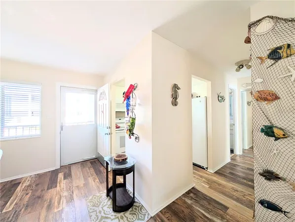 a very nice looking room with wooden floor and furniture