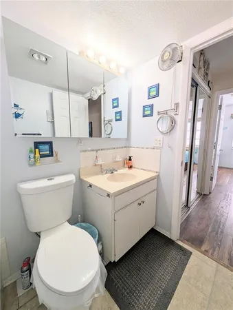 a white toilet sitting next to a bathroom sink