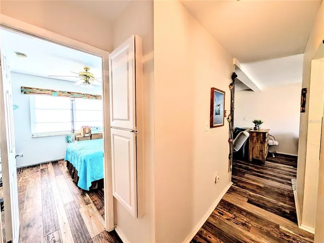 a hallway with a large window and wooden floor