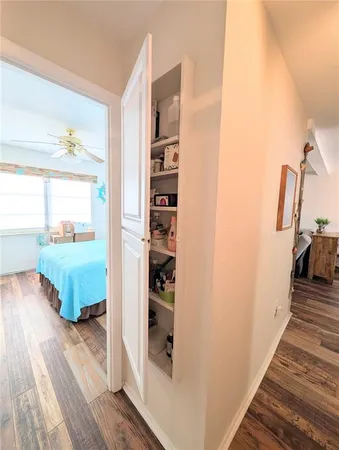 an entryway with wooden floor and windows