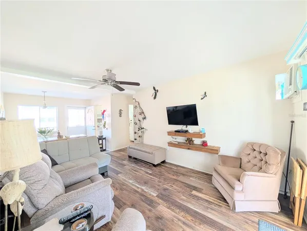 a bedroom with furniture and a flat screen tv