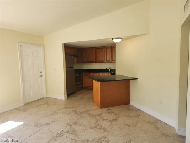 a kitchen with kitchen island cabinets and oven