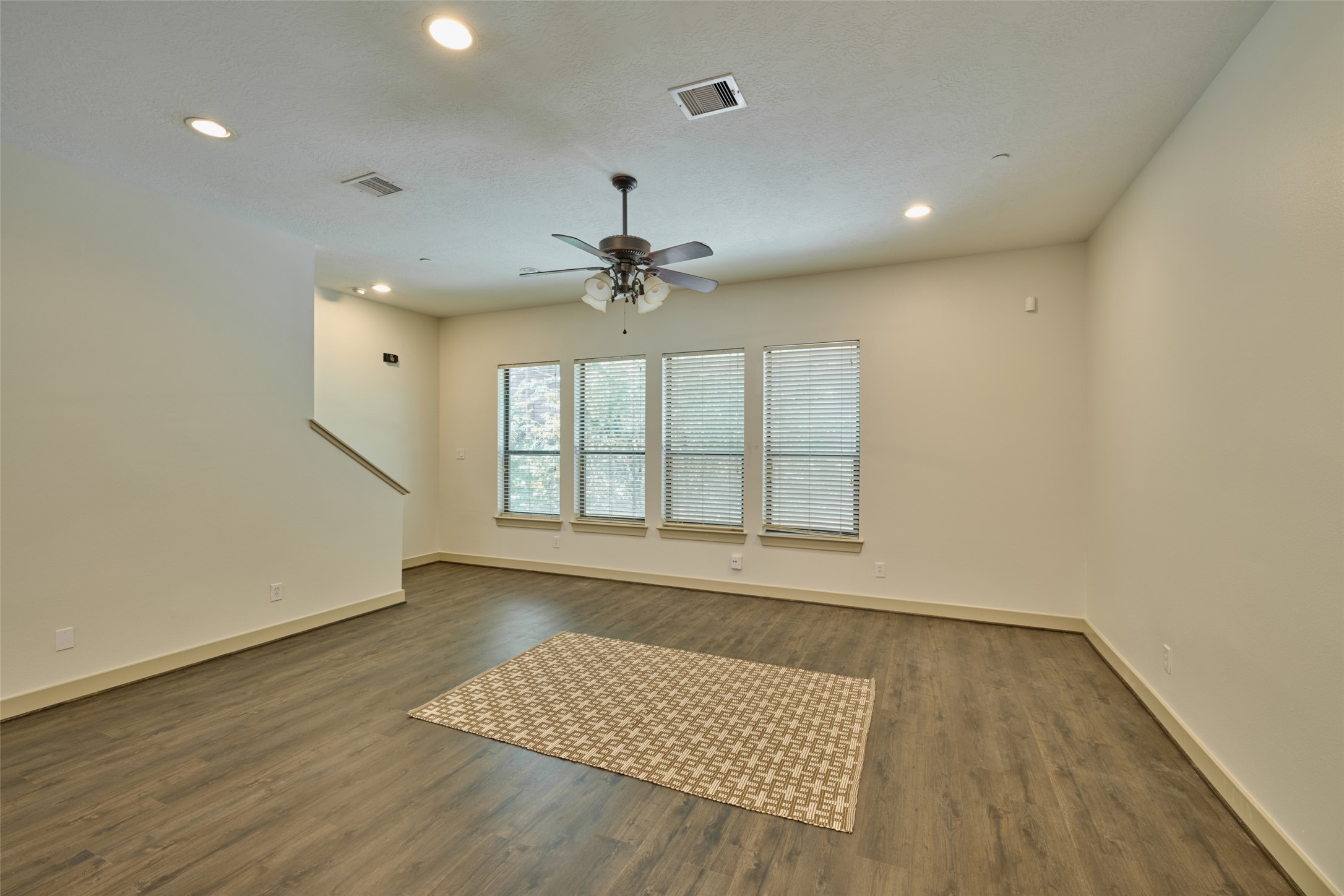 2422 Navigation Boulevard, Unit E Houston, TX 77003 - Photo 10 of 29 an empty room with wooden floor and windows
