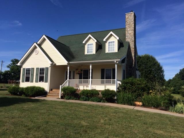 3218 Ayers Road Moneta, VA 24121 - Photo 1 of 67 a front view of a house with a yard and garage