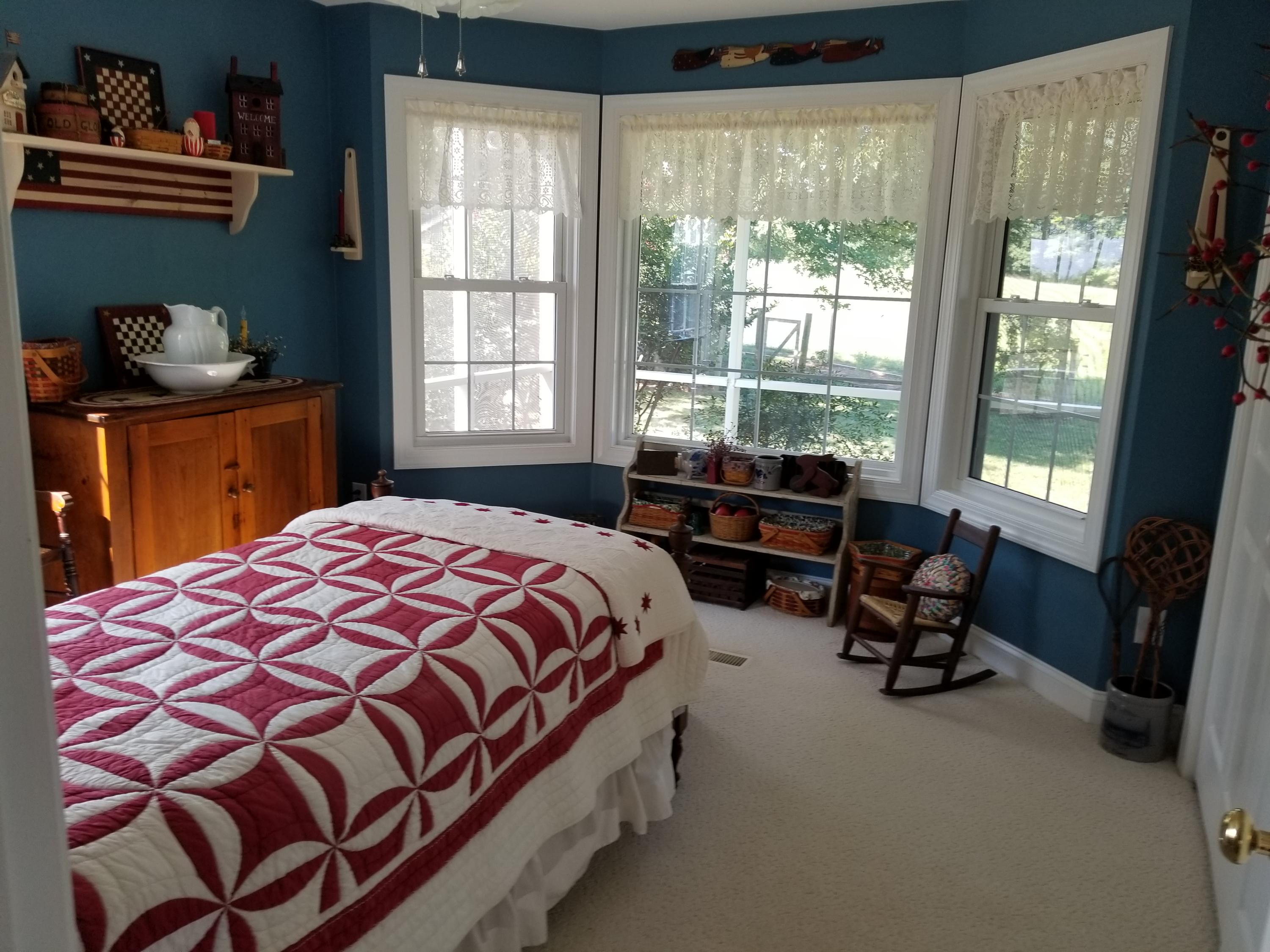 3218 Ayers Road Moneta, VA 24121 - Photo 24 of 67 a bed sitting in a bedroom next to a window