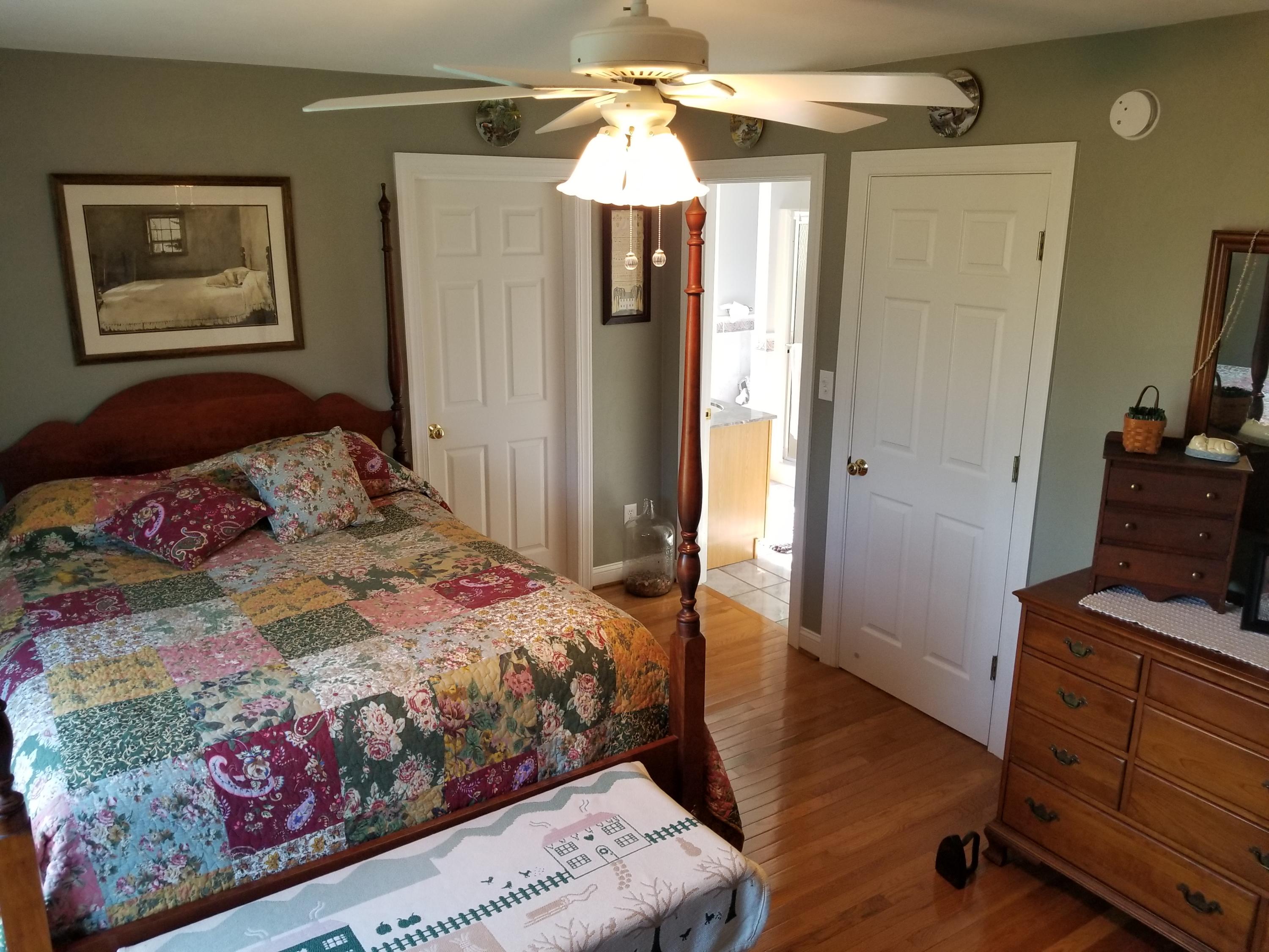 3218 Ayers Road Moneta, VA 24121 - Photo 33 of 67 a bedroom with a bed and a chandelier