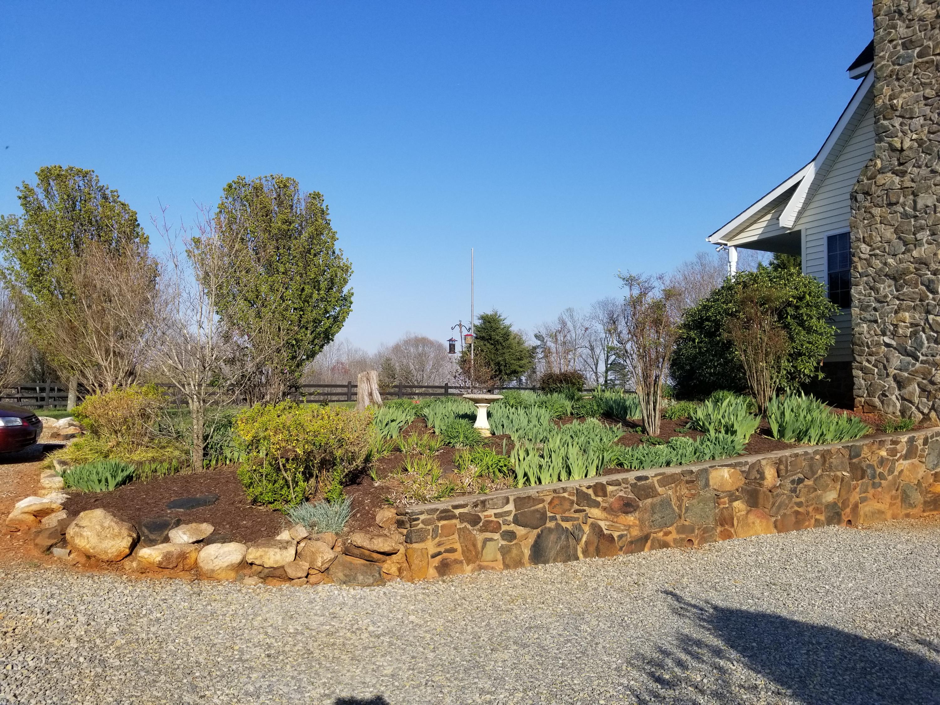 3218 Ayers Road Moneta, VA 24121 - Photo 54 of 67 a view of a garden with a fountain in the background