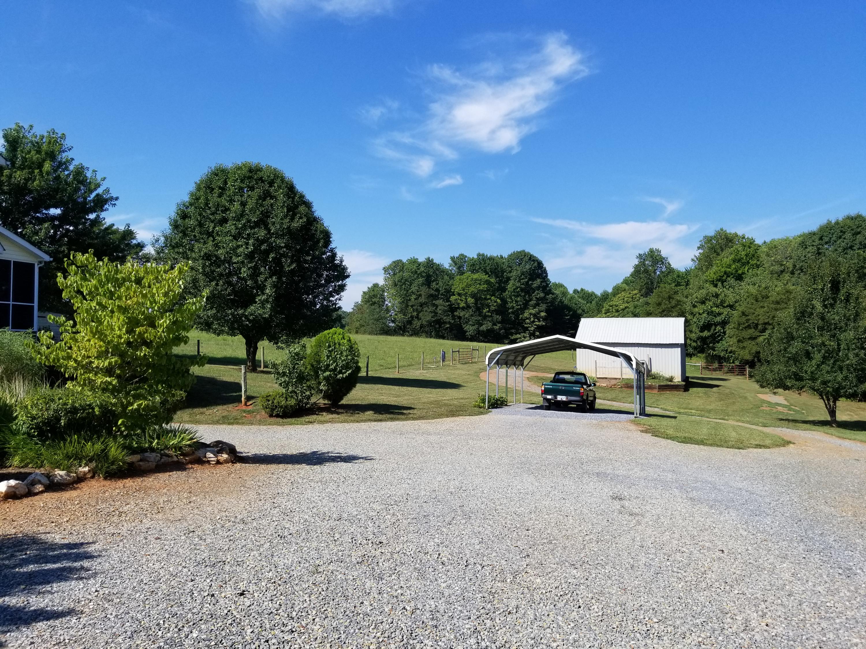 3218 Ayers Road Moneta, VA 24121 - Photo 9 of 67 a row of a house with a yard and tree in the background