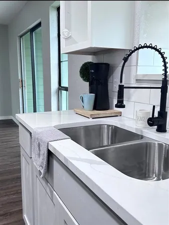 a kitchen with a sink and a mirror