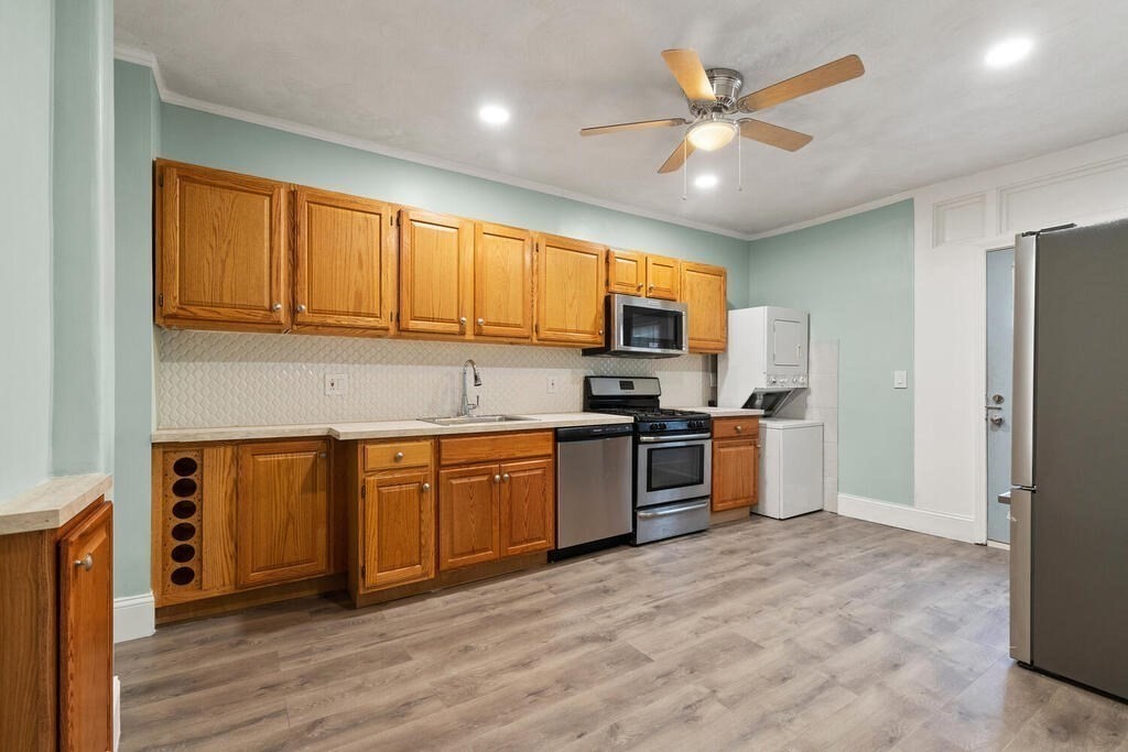 16 Mount Hood Terrace, Unit 2 Lynn, MA 01902 - Photo 13 of 28 a kitchen with granite countertop a refrigerator stove top oven and sink