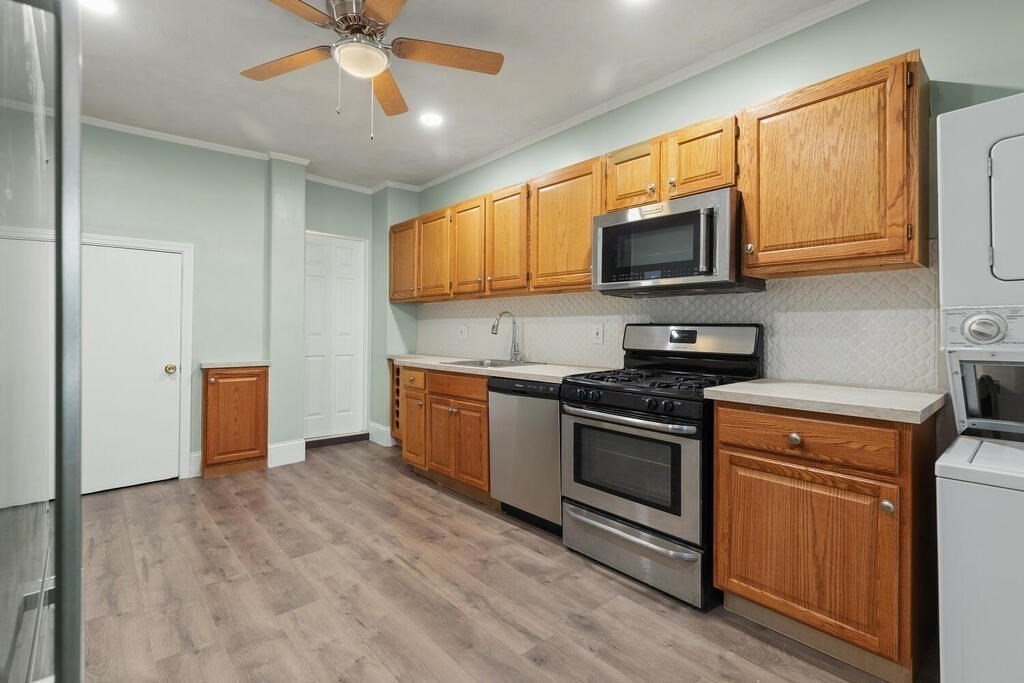16 Mount Hood Terrace, Unit 2 Lynn, MA 01902 - Photo 16 of 28 a kitchen with stainless steel appliances granite countertop a stove a sink and a refrigerator
