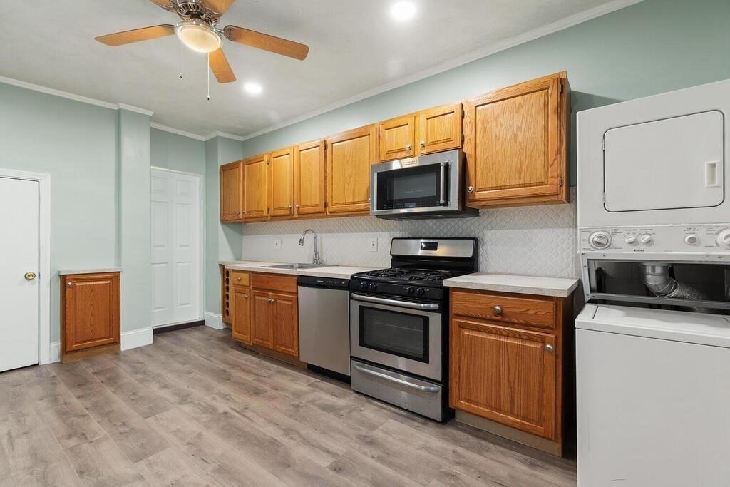 16 Mount Hood Terrace, Unit 2 Lynn, MA 01902 - Photo 17 of 28 a kitchen with stainless steel appliances granite countertop a stove sink microwave and refrigerator