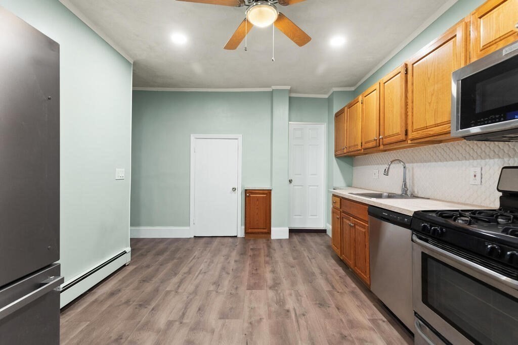 16 Mount Hood Terrace, Unit 2 Lynn, MA 01902 - Photo 20 of 28 a kitchen with stainless steel appliances granite countertop a stove and a wooden floors