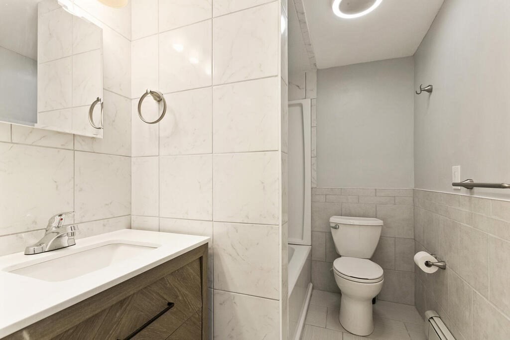 16 Mount Hood Terrace, Unit 2 Lynn, MA 01902 - Photo 23 of 28 a bathroom with a granite countertop sink toilet and shower