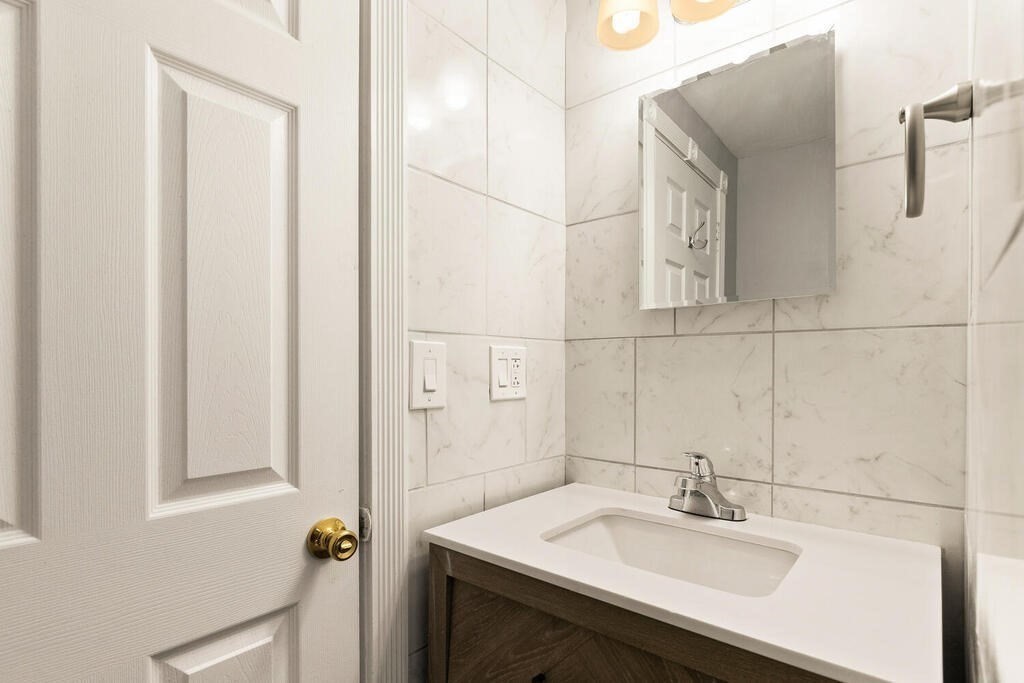 16 Mount Hood Terrace, Unit 2 Lynn, MA 01902 - Photo 24 of 28 a bathroom with a sink and a mirror