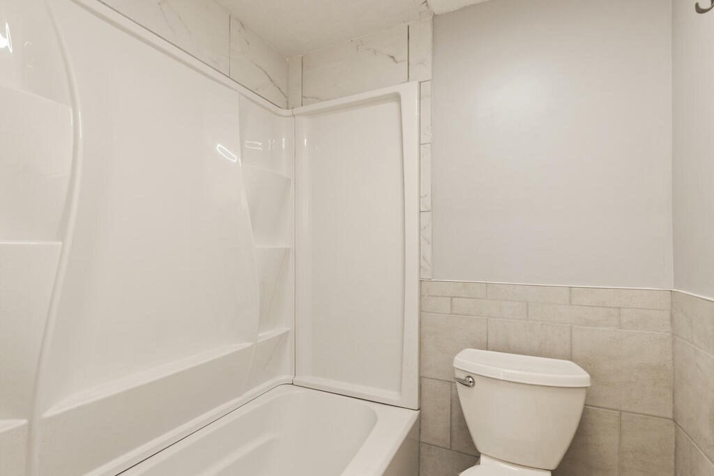 16 Mount Hood Terrace, Unit 2 Lynn, MA 01902 - Photo 26 of 28 a bathroom with a toilet and bathtub