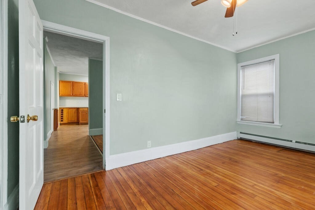 16 Mount Hood Terrace, Unit 2 Lynn, MA 01902 - Photo 6 of 28 wooden floor in an empty room with a window