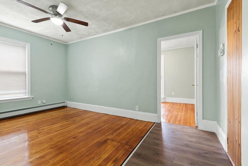 16 Mount Hood Terrace, Unit 2 Lynn, MA 01902 - Photo 9 of 28 an empty room with wooden floor cabinet and windows