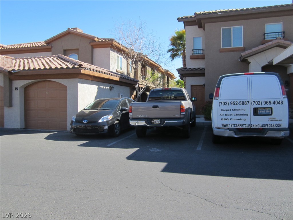 7701 West Robindale Road, Unit 262 Las Vegas, NV 89113 - Photo 2 of 26 Attached garages complement the inviting stucco exterior and tile roof of this property.