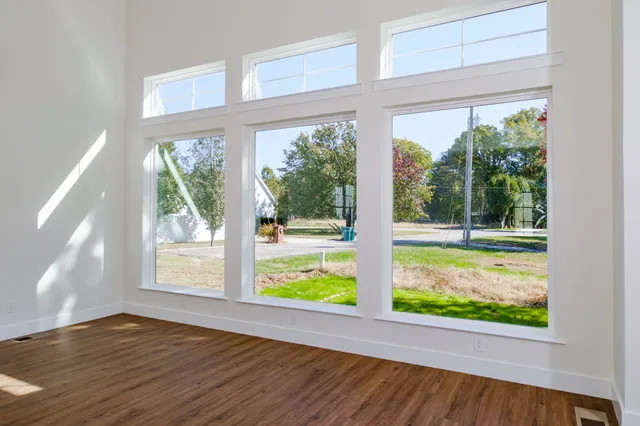 a kitchen with stainless steel appliances kitchen island granite countertop a sink cabinets and wooden floor