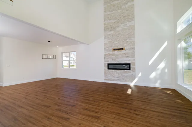 a view of kitchen with granite countertop white cabinets and white appliances