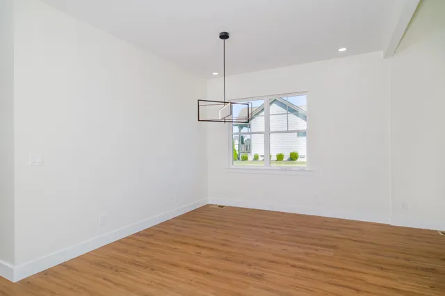 a kitchen with stainless steel appliances granite countertop a sink a stove and refrigerator