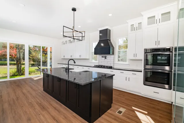 a stove top oven sitting inside of a kitchen