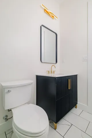 an empty room with a window and a ceiling fan