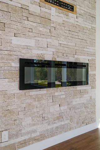 a view of a room with wooden floor and fan