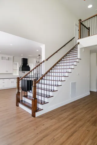 an empty room with wooden floor and window