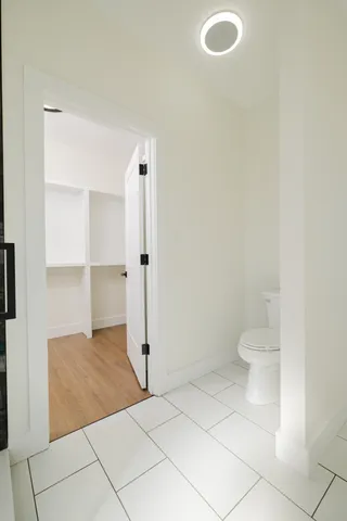 an aerial view of ocean and residential houses with outdoor space